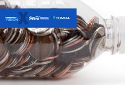 A plastic bottle filled up with pennies