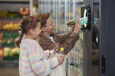 Kids using the Tomra B5 reverse vending machine