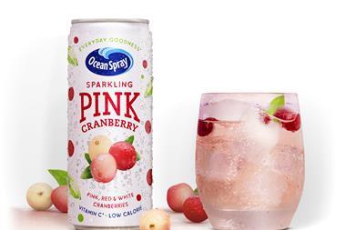 A can of Ocean Spray Sparkling Pink Cranberry next to a glass of the drink.