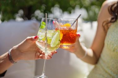 Cocktails clinking glasses outdoors in summer