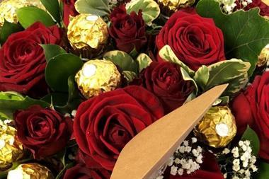 Bouquet featuring red roses and Ferrero Rocher chocolates.