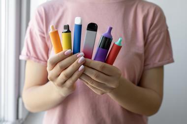 Woman's hands holding disposable vapes