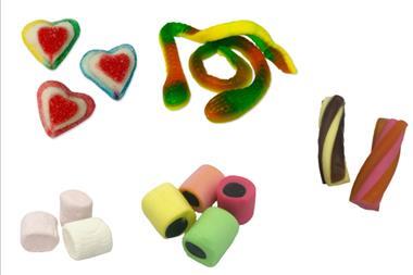 Selection of sweets including pink gummy hearts and snakes, marshmallows and liquorice