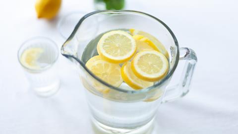 Sliced lemon fruit in glass pitcher
