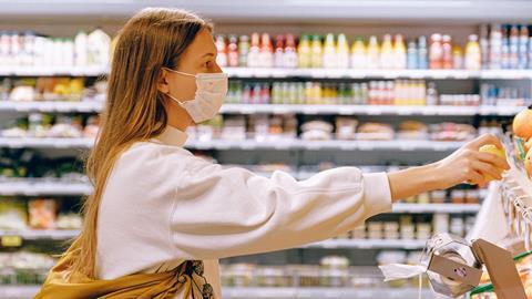 woman in mask in supermarket coronavirus