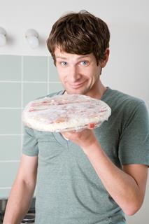 GettyImages_Man with frozen pizza_Credit Image Source