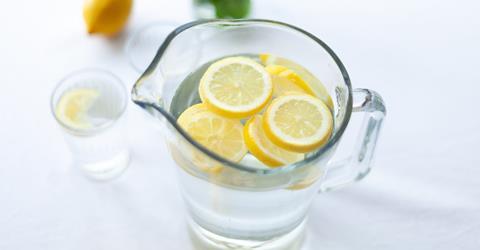 Sliced lemon fruit in glass pitcher