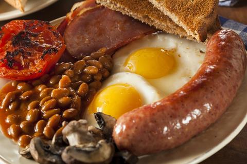 English breakfast with beans mushrooms eggs sausage bacon tomato and toast