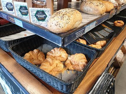 Croissants and bread in display basket in store