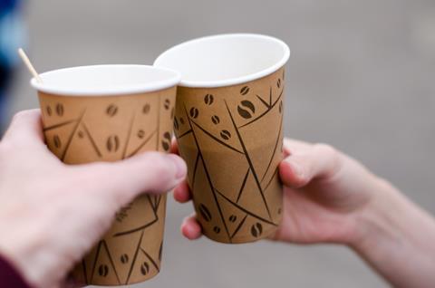 Hands clinking coffee cups on the go