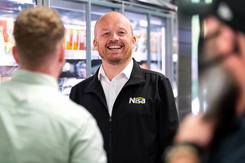 Nisa Local employee in Nisa jacket smiling
