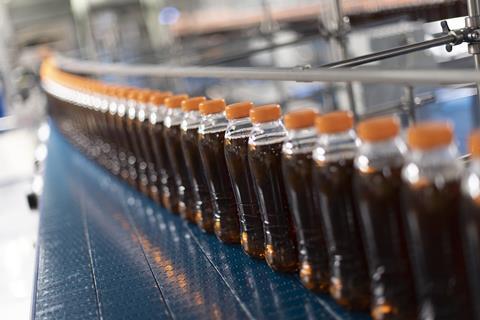 On-the-go soft drinks bottles made from recycled plastic on a production line