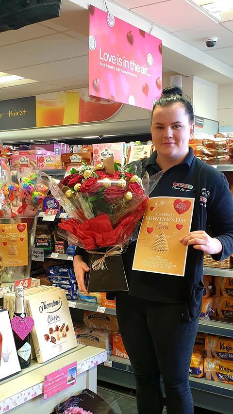 Lady in Spar London Road Bakery holding a Ferrero Rocher Rose Bouquet.