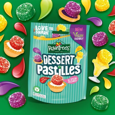 A sharing bag of Rowntrees Dessert Pastilles on a bright green fruit themed background.