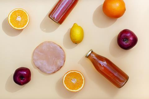 Functional drink surrounded by fruit pieces