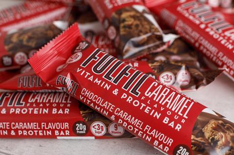 Unwrapped chocolate protein bars in red wrappers