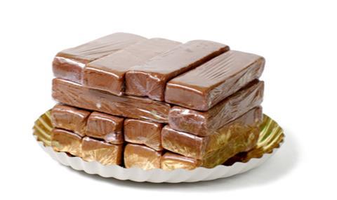 Piles of individually wrapped chocolate cake slices