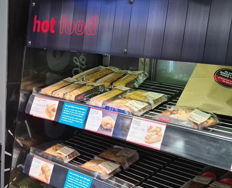A hot food cabinet with sausage rolls, bakes and turnovers.