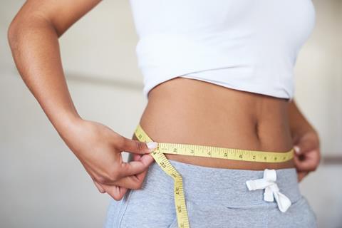 woman measuring waist