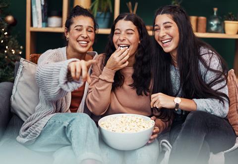 Eating popcorn on the sofa together