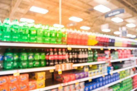 Blurred soft drinks aisle in supermarket
