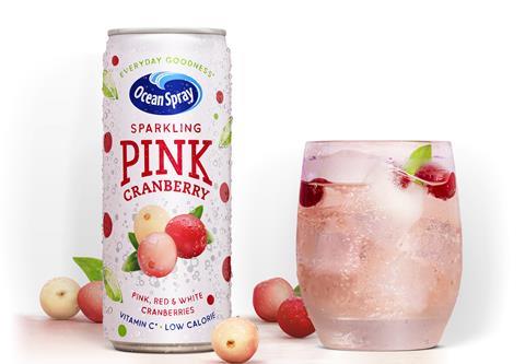 A can of Ocean Spray Sparkling Pink Cranberry next to a glass of the drink.