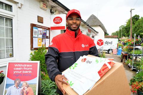 DPD driver posing outside Post Office with parcels and PO branding HIGH RES
