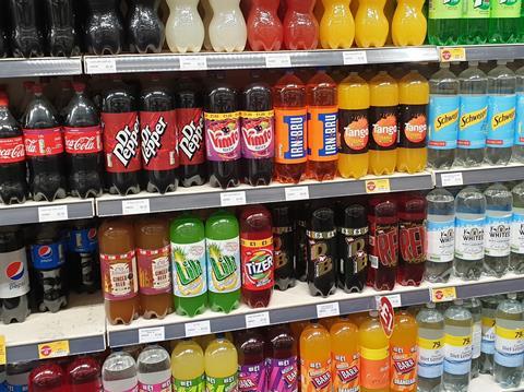 Large bottles of soft drinks on shelf in store