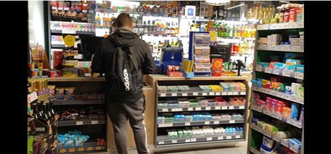 Man at counter in convenience store