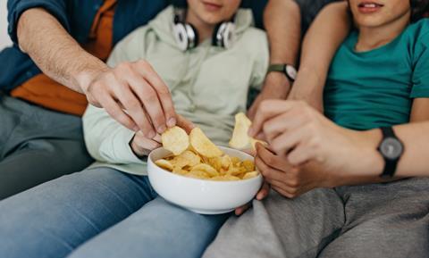 Family eating crisps