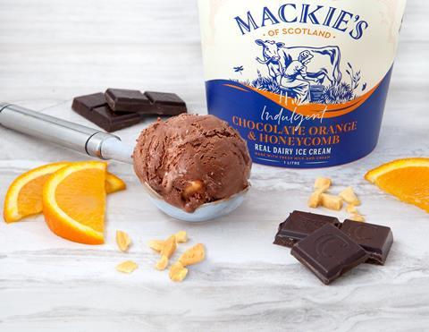 Lifestyle shot of Mackies Chocolate Orange Honeycomb ice cream with raw ingredients and scoop of ice cream.