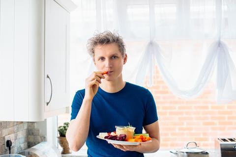 Man snacking on veg and dip