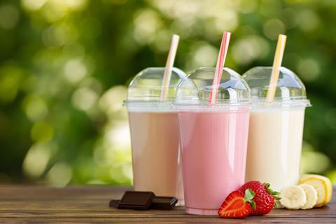 Strawberry, chocolate and banana milkshakes with raw ingredients